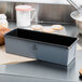A Matfer Bourgeat non-stick bread loaf pan on a counter with a loaf of bread.