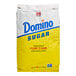 A white and yellow bag of Domino Pure Cane Granulated Sugar on a white background.