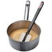 A Matfer Bourgeat spatula with a thermometer in a pot of liquid.