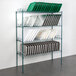 A green wire rack with trays on it.