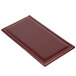 A burgundy leather Menu Solutions guest check presenter on a table.