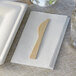 A Bamboo by EcoChoice compostable knife on a napkin.