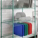 A Regency green wire rack with plates on it.
