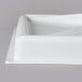 A white lid for an Avantco ice cream freezer on a gray surface.