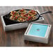 A rectangular stainless steel crate with American Metalcraft rectangular pans of food on a counter.