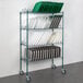 A metal rack with green trays on it.