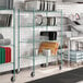 A kitchen with a Regency green wire drying rack filled with dishes and pans.