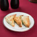 A CAC Golden Royal bright white porcelain plate with three pastries on it.