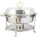 A Vollrath Classic Brass Trim Round Chafer on a table with gold and silver food warmers.