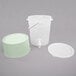 A translucent plastic beverage dispenser with a cucumber base and a white lid.
