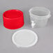 A translucent plastic beverage dispenser with a red base and lid.