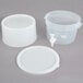A translucent plastic beverage dispenser with a white base and lid.