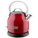 A red KitchenAid electric kettle with a silver handle.