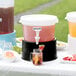 A white Choice beverage dispenser with a black base on a table with drinks.