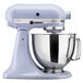 A lavender cream KitchenAid mixer with a silver bowl.