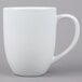 A Tuxton white porcelain mug with a handle.