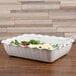A white Cambro deli crock filled with food.