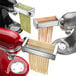 A white KitchenAid pasta machine and accessories.