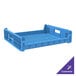 A blue plastic Orbis bakery bread tray with handles and holes.