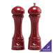 A Chef Specialties Autumn Hues candy apple red pepper mill and salt shaker on a counter.