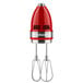 A red and silver KitchenAid hand mixer.