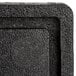 A close-up of a black plastic surface with a square shape.