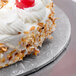 A white cake on a silver round cake drum.