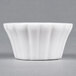 A CAC Bone White China floral ramekin with wavy edges.