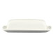 A white porcelain butter dish with a cover on a white surface.