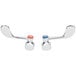 A pair of chrome and red Regency faucet handle knobs.