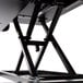 A black Luxor adjustable two-tier desktop desk on a black metal stand.