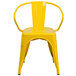 A yellow Flash Furniture metal chair with arms and a slatted back.