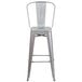 A silver galvanized steel bar stool with a vertical slat back.