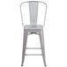 A silver metal counter height stool with a vertical slat back.