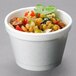 A Dart white foam food container filled with food.