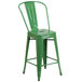 A green metal Flash Furniture counter height stool with a seat.
