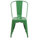 A green metal Flash Furniture chair with a vertical slat back.