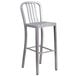 A silver metal bar stool with a vertical slat back.