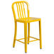 A yellow Flash Furniture metal counter height stool with vertical slat back.