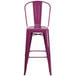 A Flash Furniture purple galvanized steel bar stool with backrest and drain hole seat.
