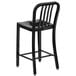 A Flash Furniture black metal counter height stool with a vertical slat back.