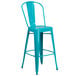 A Flash Furniture teal blue galvanized steel bar stool with a vertical slat back and drain hole seat.