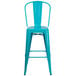 A Flash Furniture turquoise metal bar stool with a backrest and drain hole seat.