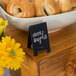 A bowl of bagels with American Metalcraft mini chalkboard tent signs that read "breakfast is served."