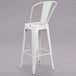 A Flash Furniture white galvanized steel bar stool with a vertical slat back and drain hole seat.