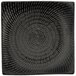 A black square Luzerne Urban porcelain plate with a spiral pattern.
