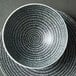 A white Luzerne porcelain bowl with a black and white circular design.