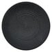 A close-up of a black Oneida Urban porcelain coupe plate with a circular spiral pattern.