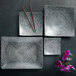 A group of Oneida Urban Storm porcelain curved square plates with chopsticks.