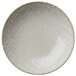 A close-up of a white Oneida Knit porcelain deep coupe plate with a textured pattern.